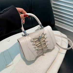 Detail view of white mini handbag featuring creative sneaker-inspired lace-up design