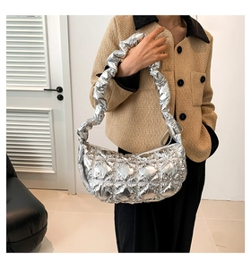 Detail of silver metallic quilted handbag with a stylish scrunchie style shoulder strap