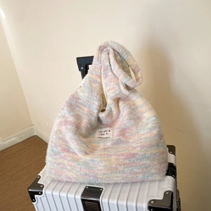 Detailed macro view of the fluffy knit striped tote bag texture with brand label