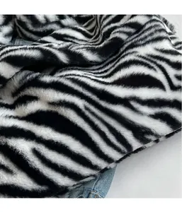 Close-up of zebra pattern plush fabric and denim material showing detailed texture