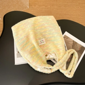 Macro view of macaron striped knit tote bag texture with interior snap button