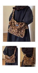 Detail shot of leopard print plush tote bag showing soft faux fur texture and long strap
