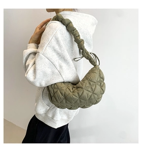 Olive green puffer shoulder bag with diamond quilting and pleated strap detail