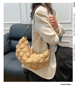Vista dettagliata della borsa beige trapuntata a mezzaluna in nylon con trama a bolle