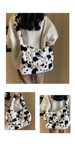 Detail of plush faux fur shoulder bag with cow print pattern and blue brand label