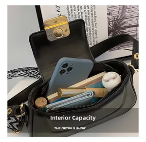 Macro view of interior storage capacity showing phone and wallet in black leather handbag