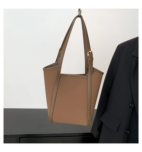 Detail of brown PU leather tote bag with adjustable shoulder strap and gold buckle