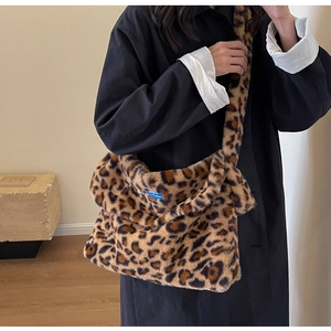 Detail showing plush faux fur texture and leopard pattern on a large shoulder bag