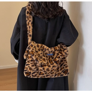 Detail of plush leopard print crossbody bag showing high-density faux fur texture and strap