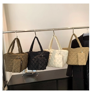 Quilted tote bag set in four colors featuring diamond stitching and small zip pouches