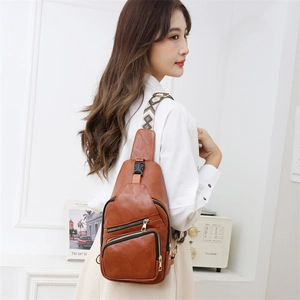 Brown PU leather crossbody bag with three gold zippers and geometric woven strap