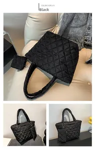 Detail view of black quilted puffer tote bag set with matching small zipper pouch