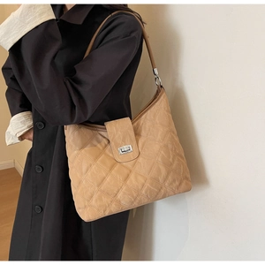 Detail showing khaki quilted hobo bag with silver turn-lock and stylish chain strap