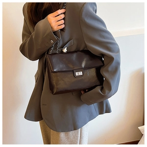 Chic black glossy leather shoulder bag with silver square buckle and chain strap detail