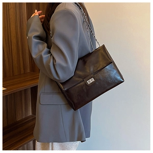 Chic black PU leather shoulder bag with silver chain strap and metal swivel lock