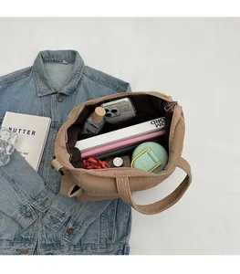 Spacious interior of corduroy tote bag showing capacity for books and daily essentials