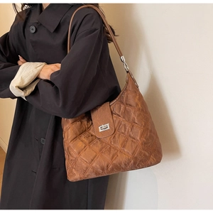 Detailed view of brown quilted hobo shoulder bag with vintage faux leather texture