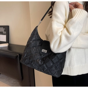 Detail shot of black quilted faux leather Hobo shoulder bag with silver turn-lock closure