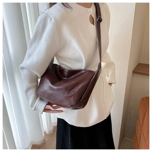 Detail view of a premium brown PU leather crossbody bag with an adjustable shoulder strap