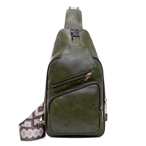 Detail view of dark green PU leather chest bag with geometric jacquard strap and zippers