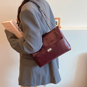 Deep burgundy faux leather shoulder bag with silver chain strap and metal turn-lock