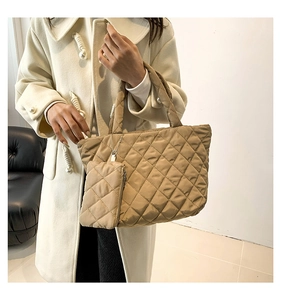 Detail view of khaki quilted cotton tote bag with a small matching zipper pouch