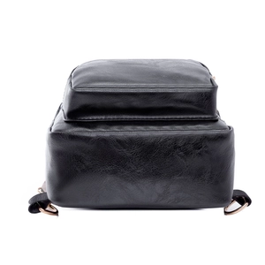Detail view of the black PU shoulder bag base with lychee texture and gold rings