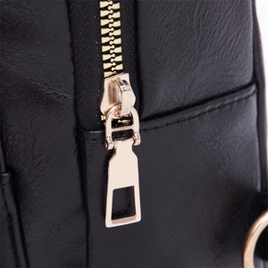 Close-up of the smooth metal zipper and gold hardware on this black leather crossbody bag