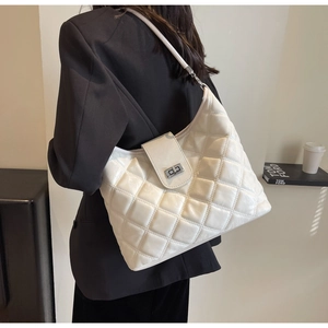 Detail of cream quilted PU shoulder bag featuring classic rhombic pattern and silver metal lock