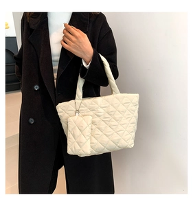 Detail of off-white quilted tote bag with matching mini coin purse and rhombus stitching