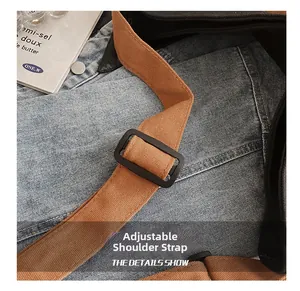 Detail shot of the durable brown canvas shoulder strap with black adjustable buckle