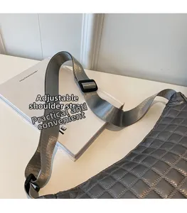 Detail of adjustable nylon shoulder strap on silver quilted PU crossbody bag
