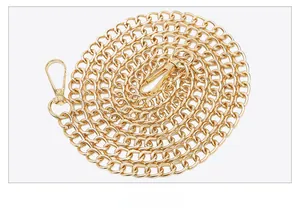 Close-up of golden metal chain strap with ring links and lobster clasps for camera bag