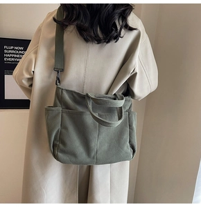 Detail of army green corduroy tote bag with multiple pockets and adjustable shoulder strap