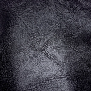 Close-up of black PU leather texture with fine litchi grain and soft wrinkle detail