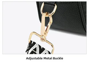 Detail of adjustable golden metal buckle and woven strap on black leather camera bag