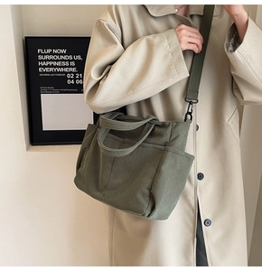 Detail of army green corduroy crossbody bag texture and canvas shoulder strap detail
