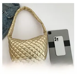 Detailed overhead view of a metallic gold quilted crescent bag with size reference