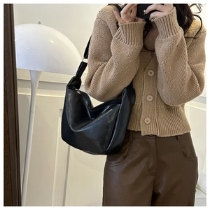 Mirror selfie showing the black matte PU leather hobo bag with a stylish wide shoulder strap
