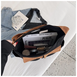 Detail showing high capacity canvas tote bag interior with tablet and books