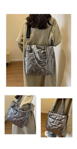 Detailed view of silver metallic quilted tote bag with padded handles and nylon strap