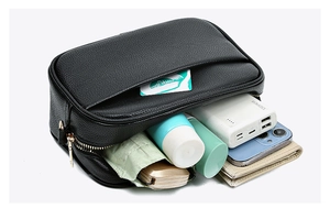 Top view of black lychee leather crossbody bag showing spacious interior with essentials