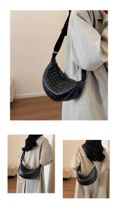 Close-up of black quilted PU leather half-moon bag with elegant stitching detail