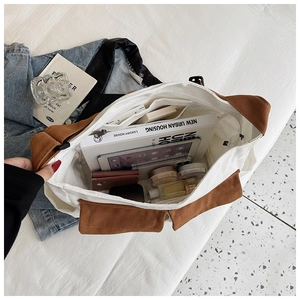 Top view of spacious canvas tote interior with pockets for books, tablet and cosmetics