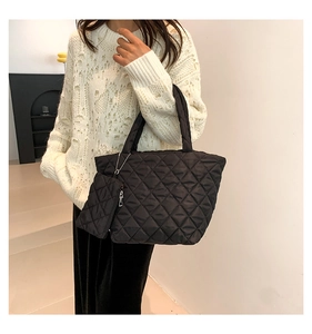 Quilted black tote bag with matching mini pouch and diamond texture detail