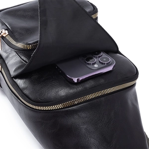 Detail of the high-quality black PU leather texture and front flap pocket on the crossbody bag