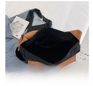 Internal view of a canvas crossbody bag showing a large compartment and zipper inner pocket