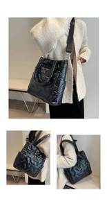 Detail of black quilted puffer tote bag with glossy finish and detachable wide strap
