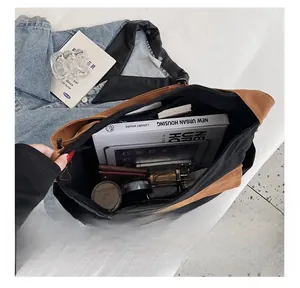 Detailed interior view of a large canvas crossbody bag with compartments for essentials