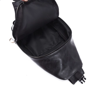 Detail view of black PU leather crossbody bag interior showing lining and zipper pocket